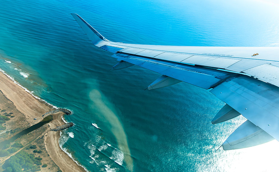Aerial view of the ocean and coastline from an airplane.
