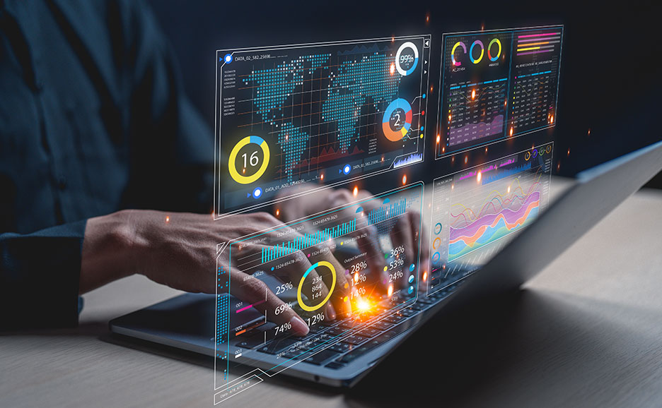A business person operating a laptop for data analysis.