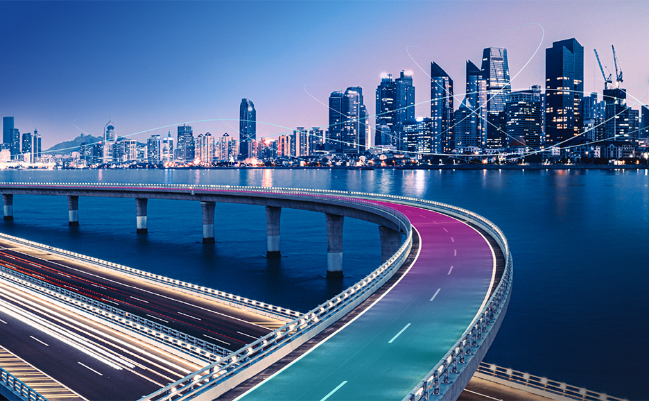 A futuristic city view with the highway alongside the river and the city on the other side of the river