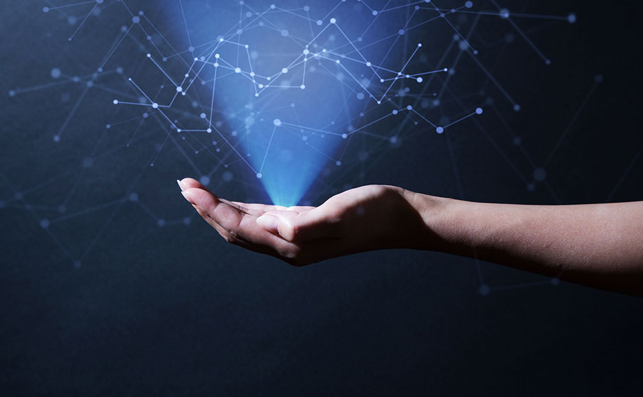 A hand holding a bright blue digital network.