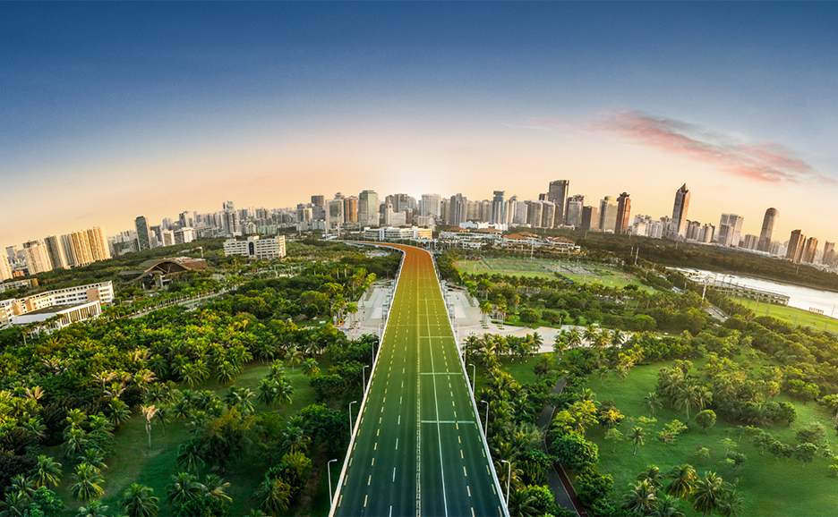 A futuristic landscape with a road running through a lush park to the edge of a city