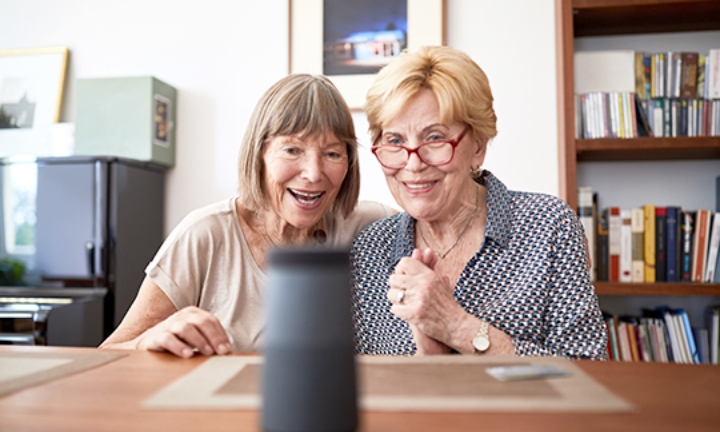Two women conversing with someone using remote equipment