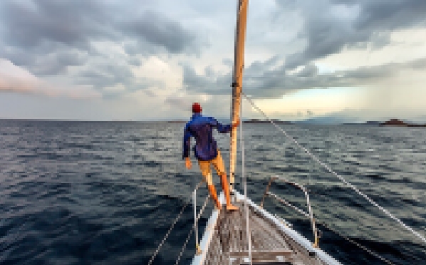A man standing on the deck of a ship