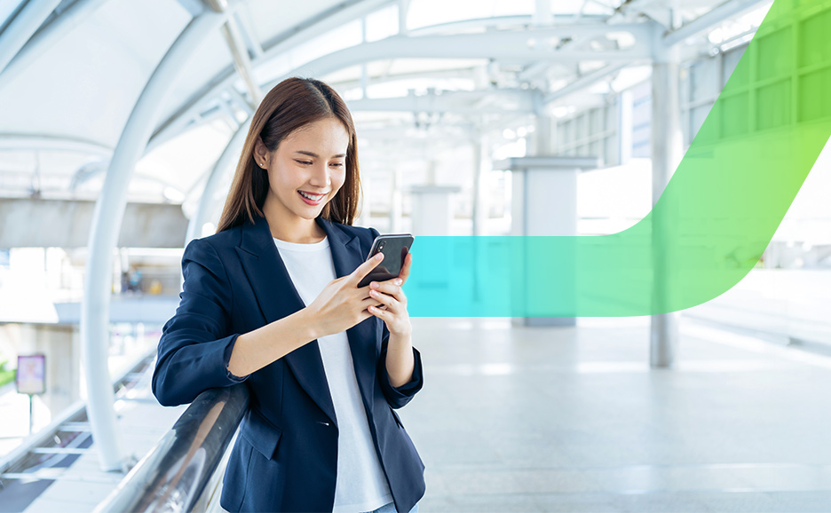 Smiling woman using smartphone